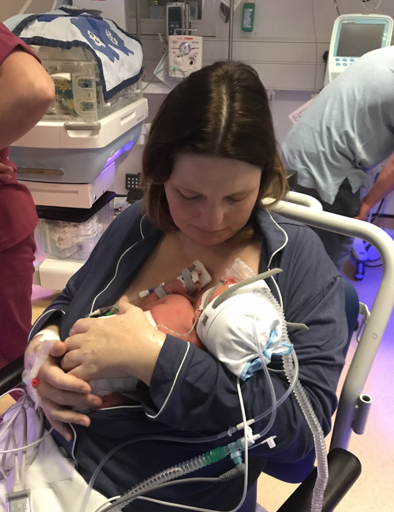 geriatric mum holding her new baby who was premature