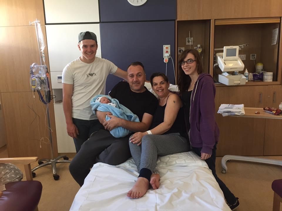 Family in hospital with newborn baby boy