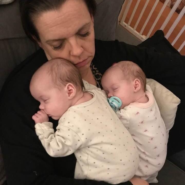 Tired new mum with her twin girls