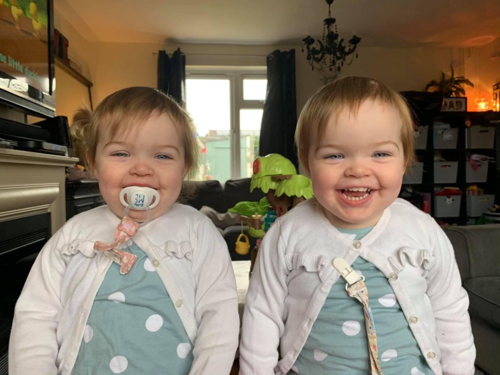smiling happy twin girls