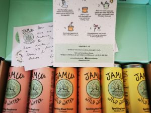 cans of jamu wild water on a box