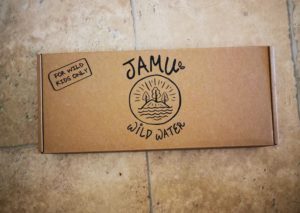 a cardboard box with Jamu wild water cans in